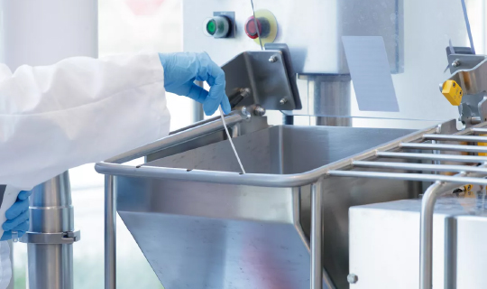 Food safety technician swabbing mixer